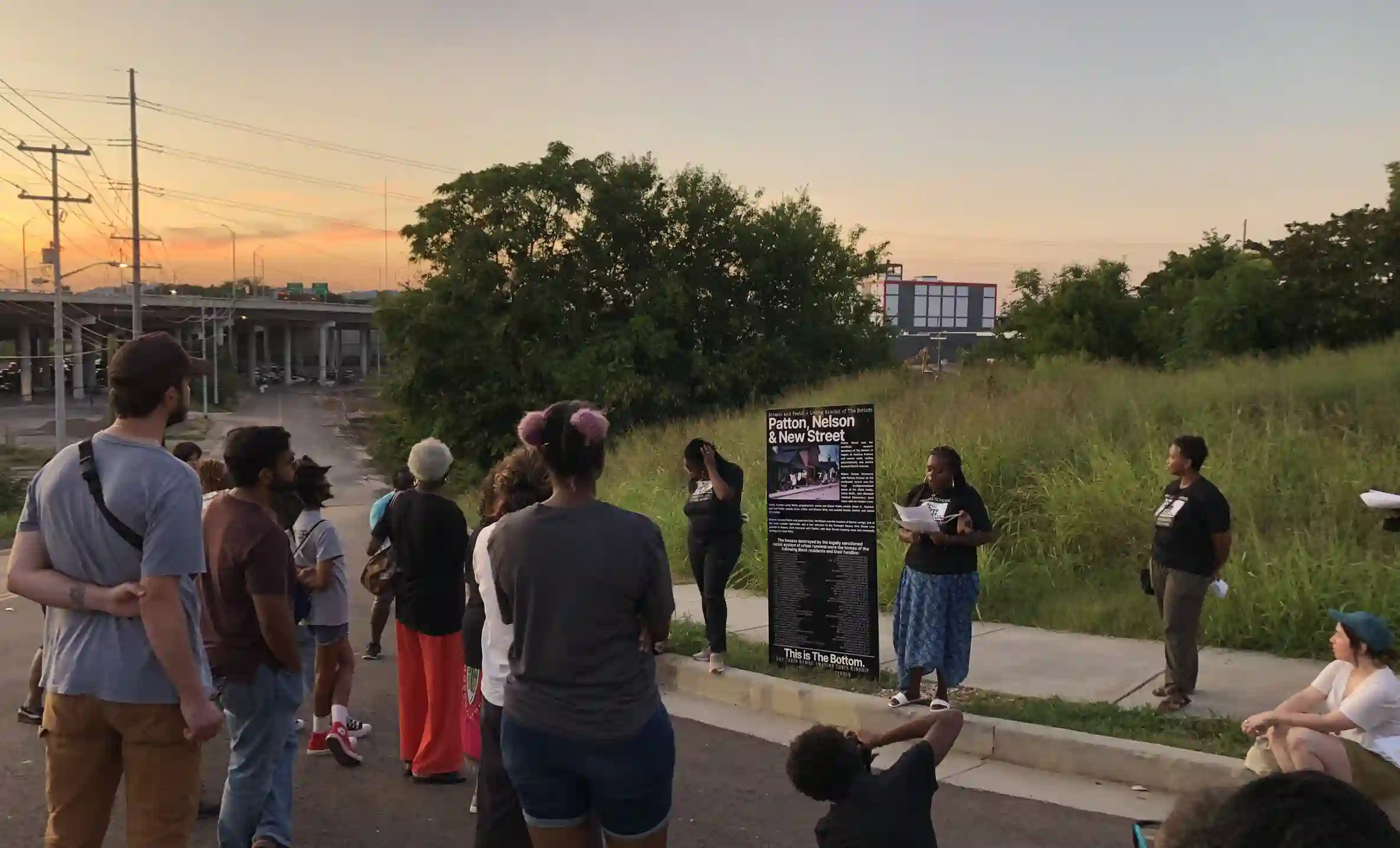 A crowd gathers as the sign is erected in The Bottom, Knoxville, TN an area that was acquisitioned by the city in the 1950s, displacing many Black families